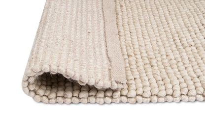 Kyra – Handwoven Braided Wool Rug in Warm Beige & Ivory