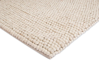 Kyra – Handwoven Braided Wool Rug in Warm Beige & Ivory