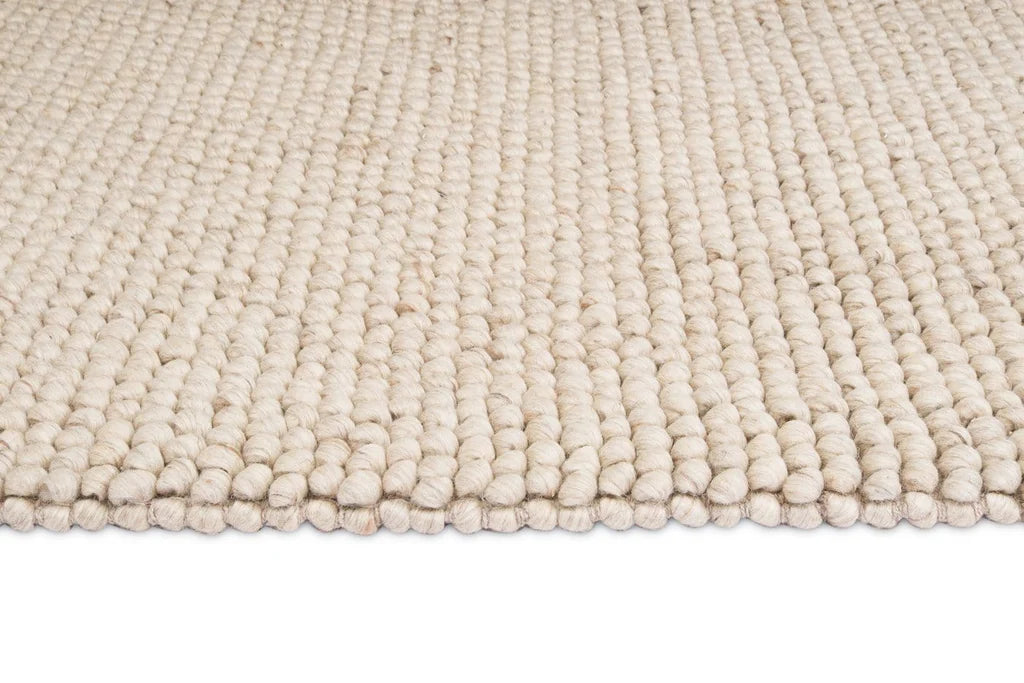 Kyra – Handwoven Braided Wool Rug in Warm Beige & Ivory