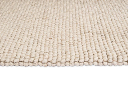 Kyra – Handwoven Braided Wool Rug in Warm Beige & Ivory